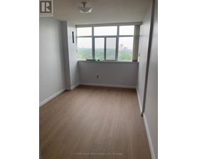 A room with a window overlooking a cityscape.