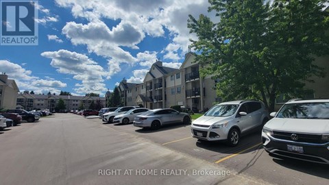 A parking lot with cars and a building in the background.