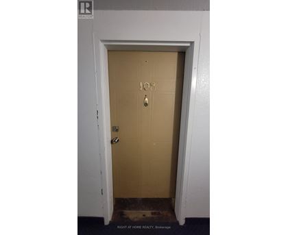 A brown door with the number 108 on it.