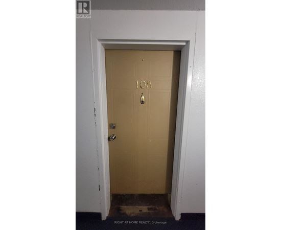 A brown door with the number 108 on it.