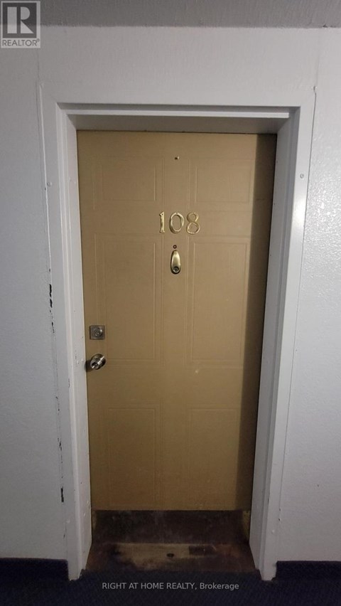 A brown door with the number 108 on it.