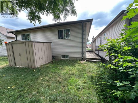 A backyard with a shed and a deck.