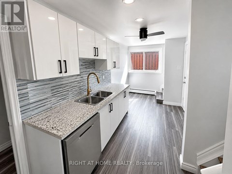 A kitchen with a sink and a window.