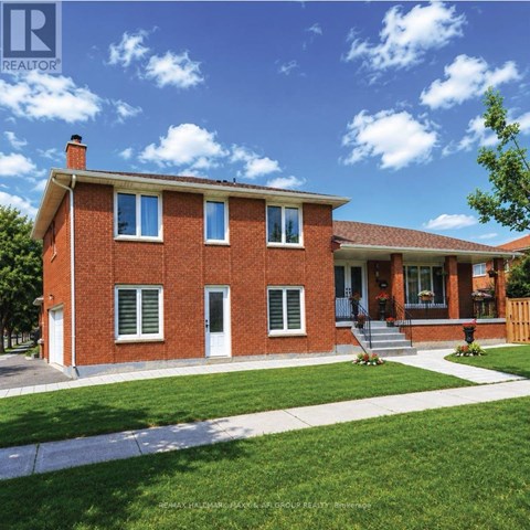 A red brick house with a white door and windows.