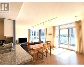 A kitchen with granite countertops and a dining table with chairs.