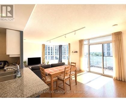 A kitchen with granite countertops and a dining table with chairs.