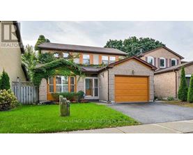 A house with a brown garage door is for sale.