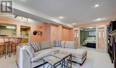 A living room with a grey couch and a coffee table.