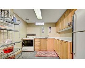 A kitchen with wooden cabinets and a white refrigerator.