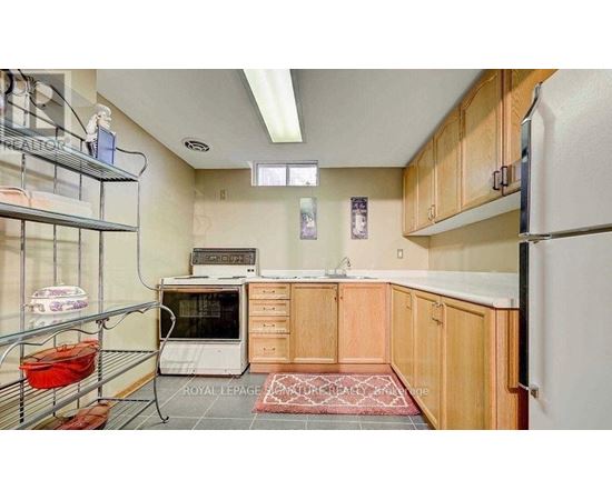 A kitchen with wooden cabinets and a white refrigerator.