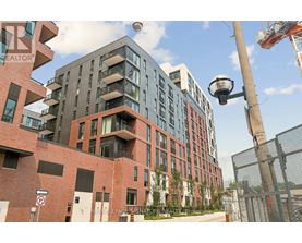 A modern multi-story building with a mix of brick and glass facade.