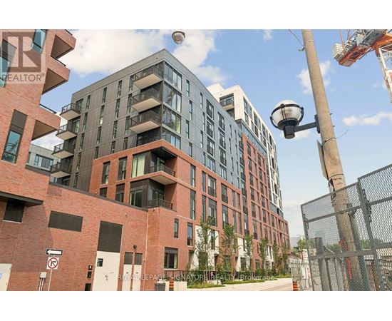 A modern multi-story building with a mix of brick and glass facade.