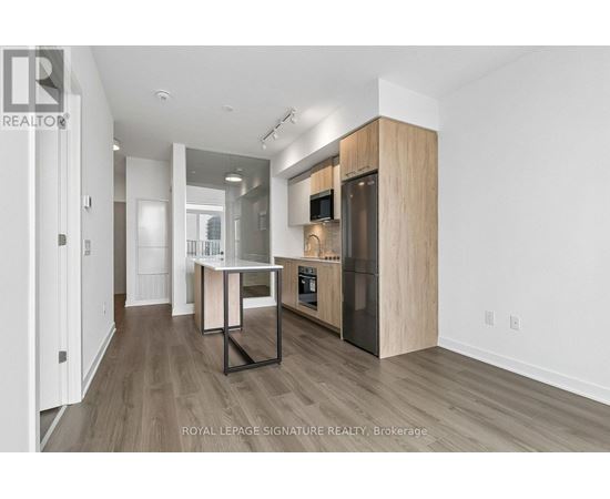 A modern kitchen with wooden cabinets and a central island.