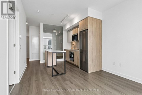 A modern kitchen with wooden cabinets and a central island.