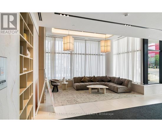 A living room with a couch, chairs, and a coffee table.