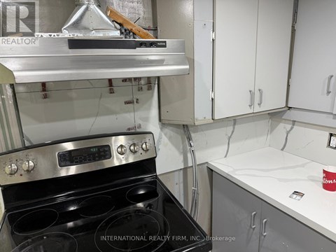 A kitchen with a stove and cabinets.