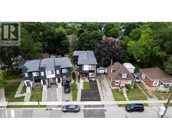 A bird's eye view of a neighborhood with houses and cars.