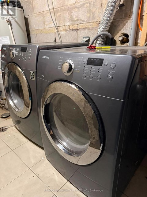 A front load washing machine is in a laundry room.