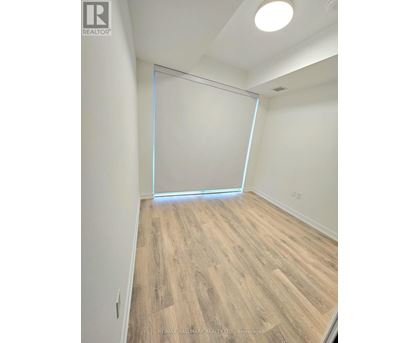 A room with a sliding door and wooden flooring.