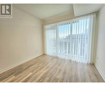 A room with a view of a cityscape through the window.