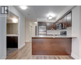 A kitchen with a wooden counter top and stainless steel appliances.
