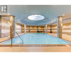 A large indoor swimming pool with the words "SHALLOW AREA" written on the bottom.