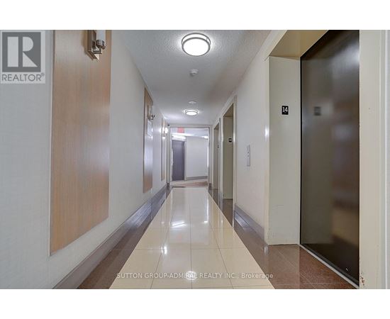 A hallway with a light on the ceiling and doors on the right.