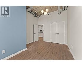 A room with a blue wall and wooden flooring.
