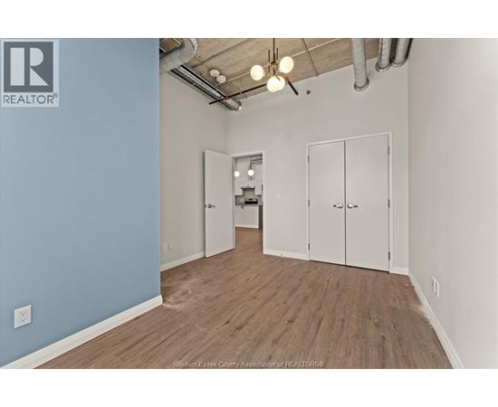 A room with a blue wall and wooden flooring.