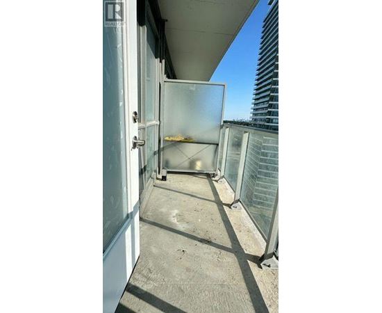 A balcony with a glass door and a white door.