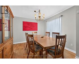 A dining room with a wooden table and chairs.