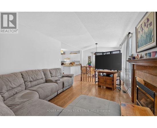 A living room with a grey sofa and a television.