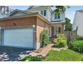 A house with a white garage door and brick exterior.