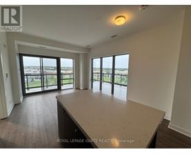 A spacious room with a large window overlooking a cityscape.