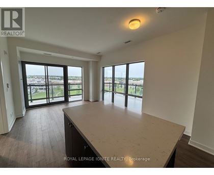 A spacious room with a large window overlooking a cityscape.