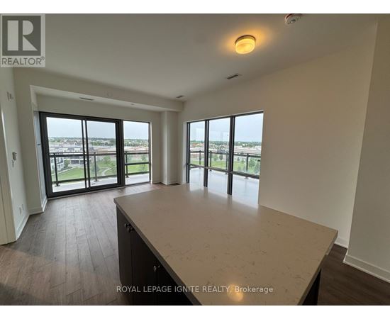 A spacious room with a large window overlooking a cityscape.