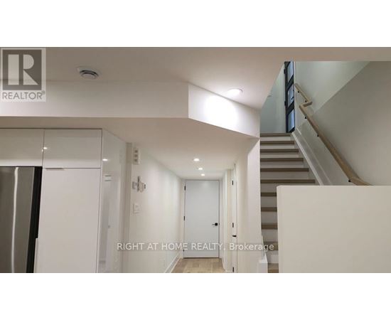A hallway with a staircase on the right side.