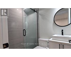 A bathroom with a sink, mirror, and toilet.