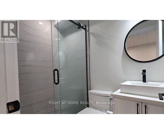 A bathroom with a sink, mirror, and toilet.