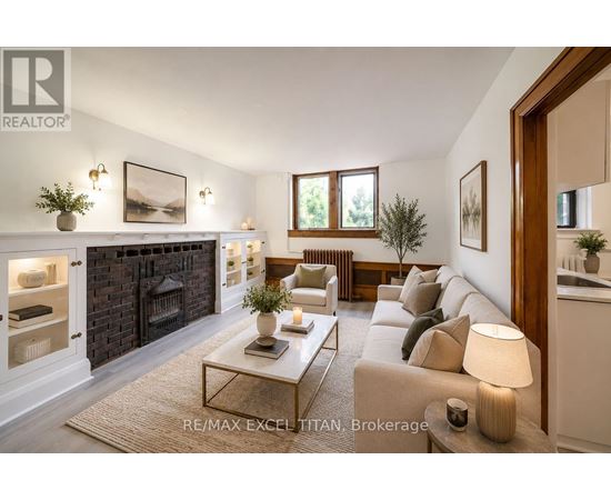 A well-lit living room with a fireplace and a couch.