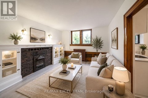 A well-lit living room with a fireplace and a couch.
