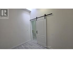 A white door with a black handle is in a room with white walls.
