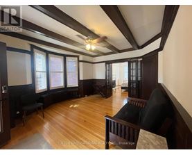 A room with wooden floors and a ceiling fan.