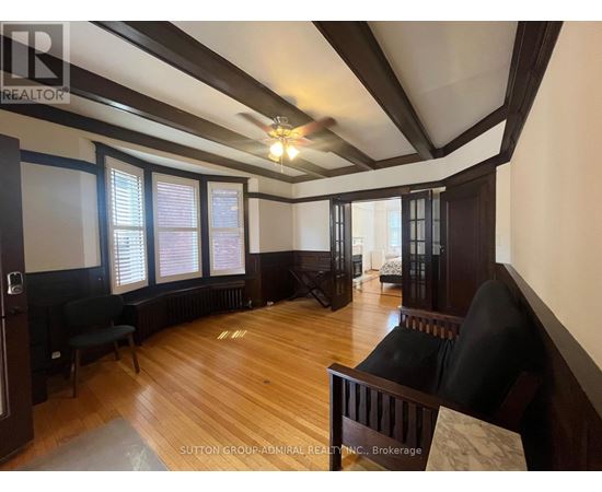 A room with wooden floors and a ceiling fan.