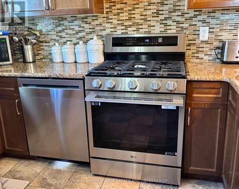 A stainless steel oven with a digital display is in a kitchen.