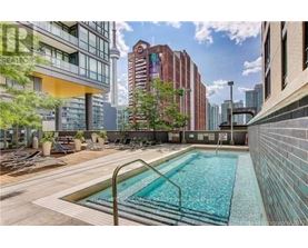 A pool surrounded by buildings and trees.