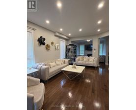 A living room with a white couch and a coffee table.