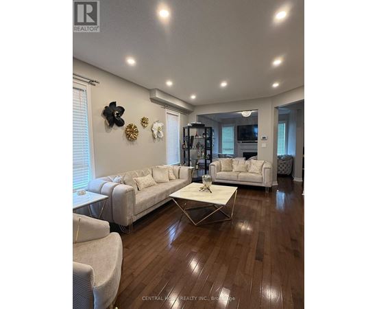 A living room with a white couch and a coffee table.