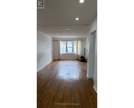 A room with wooden floors and white walls.