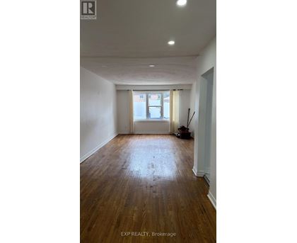 A room with wooden floors and white walls.
